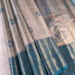 Silver and Teal Tissue Saree with Floral Motifs and Rich Zari Border