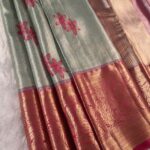 Pastel Green Tissue Saree with Floral Motifs and Rich Zari Woven Border