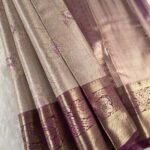 Beige Coloured Tissue Saree with Intricate Floral Motifs and Rich Zari Border