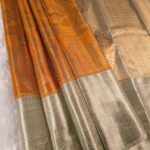 Orange Coloured Tissue Silk Saree with Paisley Motifs and Zari Woven Border