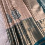 Beige and Teal Tissue Saree with Intricate Peacock Motifs and Rich Zari Border