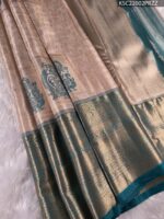 Beige and Teal Tissue Saree with Intricate Peacock Motifs and Rich Zari Border