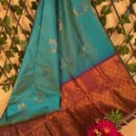 Teal and Copper Semi Soft Silk Saree with Floral Motifs and Rich Border Design